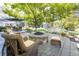 Charming backyard with a stone fire pit, wicker chairs, and a bench, ideal for outdoor gatherings at 4483 W Cottonwood Pl, Littleton, CO 80123