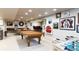 Finished basement with pool table, foosball, bar, and ample recreational space at 4483 W Cottonwood Pl, Littleton, CO 80123