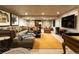 Finished basement with a stone accent wall, lounge seating, media, and carpet at 4483 W Cottonwood Pl, Littleton, CO 80123