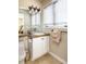 Well-lit bathroom features white cabinetry, granite countertop, framed mirror, and decorative lighting at 4483 W Cottonwood Pl, Littleton, CO 80123
