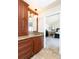 Charming bathroom vanity with warm lighting and granite counters adjacent to a doorway to a bedroom at 4483 W Cottonwood Pl, Littleton, CO 80123
