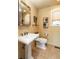 Well-lit bathroom features a pedestal sink and ceramic tile flooring at 4483 W Cottonwood Pl, Littleton, CO 80123