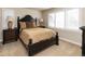 Comfortable bedroom featuring a black bed frame, neutral bedding, and bright natural light at 4483 W Cottonwood Pl, Littleton, CO 80123