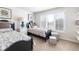 Bright bedroom with two beds, shuttered windows, neutral carpet, and decorative accents at 4483 W Cottonwood Pl, Littleton, CO 80123