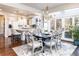 Elegant dining room with chandelier, hardwood floors, and patio doors to the backyard at 4483 W Cottonwood Pl, Littleton, CO 80123