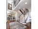 Spacious foyer features a staircase with wood and white trim, leading to the upper level at 4483 W Cottonwood Pl, Littleton, CO 80123