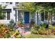 Inviting front entry with a vibrant blue door, surrounded by colorful flowers and plants at 4483 W Cottonwood Pl, Littleton, CO 80123
