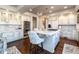 Bright and airy kitchen with stainless appliances, island seating, and modern pendants at 4483 W Cottonwood Pl, Littleton, CO 80123