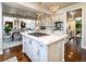 Well-lit kitchen with a large center island with cooktop and open views to dining and living areas at 4483 W Cottonwood Pl, Littleton, CO 80123