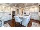 Bright kitchen featuring an island with seating, stainless steel appliances, and ample cabinet space at 4483 W Cottonwood Pl, Littleton, CO 80123