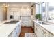 Elegant kitchen showcasing custom cabinetry, an island cooktop, and stainless steel appliances at 4483 W Cottonwood Pl, Littleton, CO 80123
