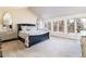 Large main bedroom with vaulted ceilings, large windows and carpeted flooring at 4483 W Cottonwood Pl, Littleton, CO 80123