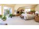 Bright main bedroom featuring a large window, plants and soft carpet at 4483 W Cottonwood Pl, Littleton, CO 80123