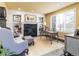 Bright office with built-in bookshelves, fireplace, and plantation shutters at 4483 W Cottonwood Pl, Littleton, CO 80123