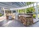 Outdoor kitchen with a built-in grill, sink, and stone countertop, perfect for outdoor cooking and entertaining at 4483 W Cottonwood Pl, Littleton, CO 80123