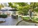 Spacious patio with a dining table, seating area, and lush greenery, perfect for outdoor dining and relaxation at 4483 W Cottonwood Pl, Littleton, CO 80123
