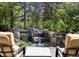 Backyard waterfall feature surrounded by mature trees, visible from seating area at 4483 W Cottonwood Pl, Littleton, CO 80123