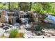 Beautiful backyard waterfall surrounded by boulders and rocks at 4483 W Cottonwood Pl, Littleton, CO 80123