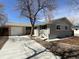 Charming single-story home features a long driveway, attached garage, and well-maintained landscaping at 123 Emerald St, Broomfield, CO 80020