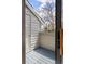Private balcony with wooden deck and railing, offering peaceful outdoor space at 3600 S Pierce St # 7-201, Denver, CO 80235