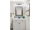 Bright bathroom with a white vanity, blue tile backsplash, and modern black fixtures at 3600 S Pierce St # 7-201, Denver, CO 80235