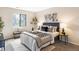 Calm bedroom features a bed, a large window, bench, and tasteful decor at 3600 S Pierce St # 7-201, Denver, CO 80235
