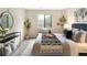 Well-lit bedroom with a queen bed, modern decor, and a view of the outdoors at 3600 S Pierce St # 7-201, Denver, CO 80235