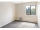 Empty carpeted bedroom, window letting in natural light at 3600 S Pierce St # 7-201, Denver, CO 80235