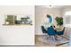 Cozy dining area featuring a modern round table, stylish blue chairs, and decor near the kitchen at 3600 S Pierce St # 7-201, Denver, CO 80235