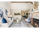 Bright living room features a fireplace, comfortable seating, and decor at 3600 S Pierce St # 7-201, Denver, CO 80235