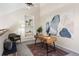 Bright office space features a wooden desk and a painted accent wall at 3600 S Pierce St # 7-201, Denver, CO 80235