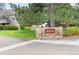 Community sign for Academy Pointe with mature trees and landscaping at 3600 S Pierce St # 7-201, Denver, CO 80235