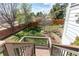 Multi-tiered backyard with retaining wall, lush lawn, privacy fence and deck with stairs at 9754 Las Colinas Dr, Lone Tree, CO 80124