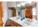 Bathroom features a spacious vanity with dual sinks, framed mirror, and a shower tub at 9754 Las Colinas Dr, Lone Tree, CO 80124