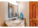 Granite countertop on vanity, decorative mirror, and door at 9754 Las Colinas Dr, Lone Tree, CO 80124