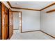 Neutral bedroom with hardwood trim and open door to the rest of the house at 9754 Las Colinas Dr, Lone Tree, CO 80124