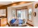 Breakfast nook features a round table, four chairs, and large windows with access to a deck and beautiful views at 9754 Las Colinas Dr, Lone Tree, CO 80124