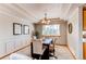 Formal dining room features modern lighting, elegant décor, and a serene view from large windows at 9754 Las Colinas Dr, Lone Tree, CO 80124