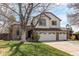 Spacious home with a brick and siding facade, a three-car garage, and a well-manicured lawn at 9754 Las Colinas Dr, Lone Tree, CO 80124