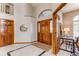 Elegant foyer features a high ceiling, tile flooring, and a beautiful wood door with glass accents at 9754 Las Colinas Dr, Lone Tree, CO 80124