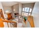 Grand foyer with high ceilings, wooden staircase, chandelier, and bright natural light from large windows at 9754 Las Colinas Dr, Lone Tree, CO 80124