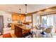 Charming eat-in kitchen with wooden cabinets, granite countertops, and tile backsplash, adjacent to a breakfast nook at 9754 Las Colinas Dr, Lone Tree, CO 80124