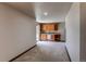 Living area features a wet bar with wooden cabinets, mini refrigerator, and access to the outdoors at 9754 Las Colinas Dr, Lone Tree, CO 80124