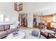 Open-concept living room with a fireplace and comfortable seating that flows into the kitchen, perfect for entertaining at 9754 Las Colinas Dr, Lone Tree, CO 80124