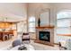 Open-concept living room flows into the kitchen, with a fireplace, large windows, and a seating area at 9754 Las Colinas Dr, Lone Tree, CO 80124