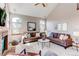 Spacious living room featuring a fireplace, large windows and plush seating, perfect for relaxation and entertainment at 9754 Las Colinas Dr, Lone Tree, CO 80124