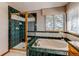 Main bathroom with a tub, shower, and a large window that provides plenty of natural light at 9754 Las Colinas Dr, Lone Tree, CO 80124