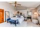 Bright main bedroom features a large bed, plush seating, and convenient access to the en-suite bathroom at 9754 Las Colinas Dr, Lone Tree, CO 80124