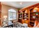 Cozy office featuring custom built-in bookshelves, and ample natural light from the large window at 9754 Las Colinas Dr, Lone Tree, CO 80124