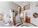Elegant staircase with wood railings and plush carpeting, bathed in natural light from large windows at 9754 Las Colinas Dr, Lone Tree, CO 80124